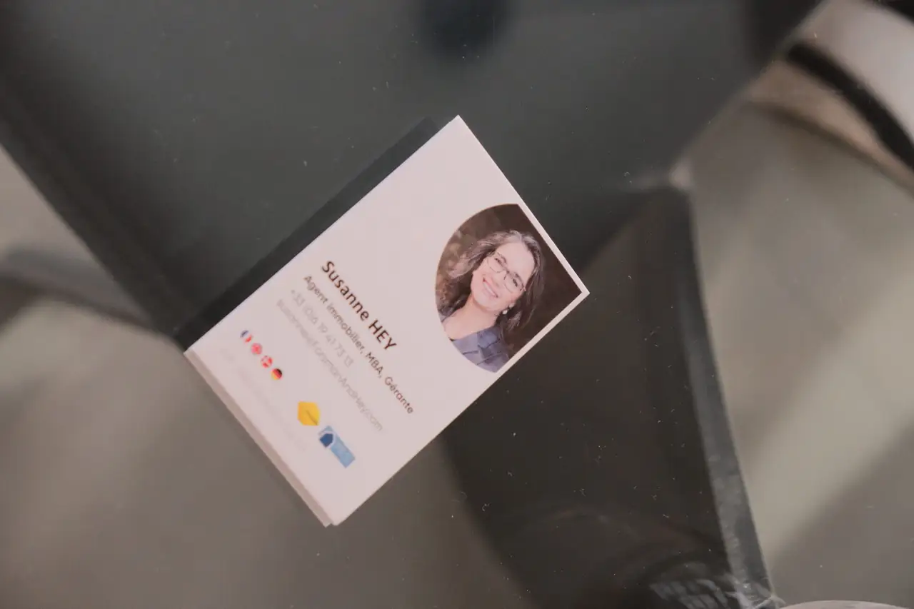 The agency's business card on a glass table